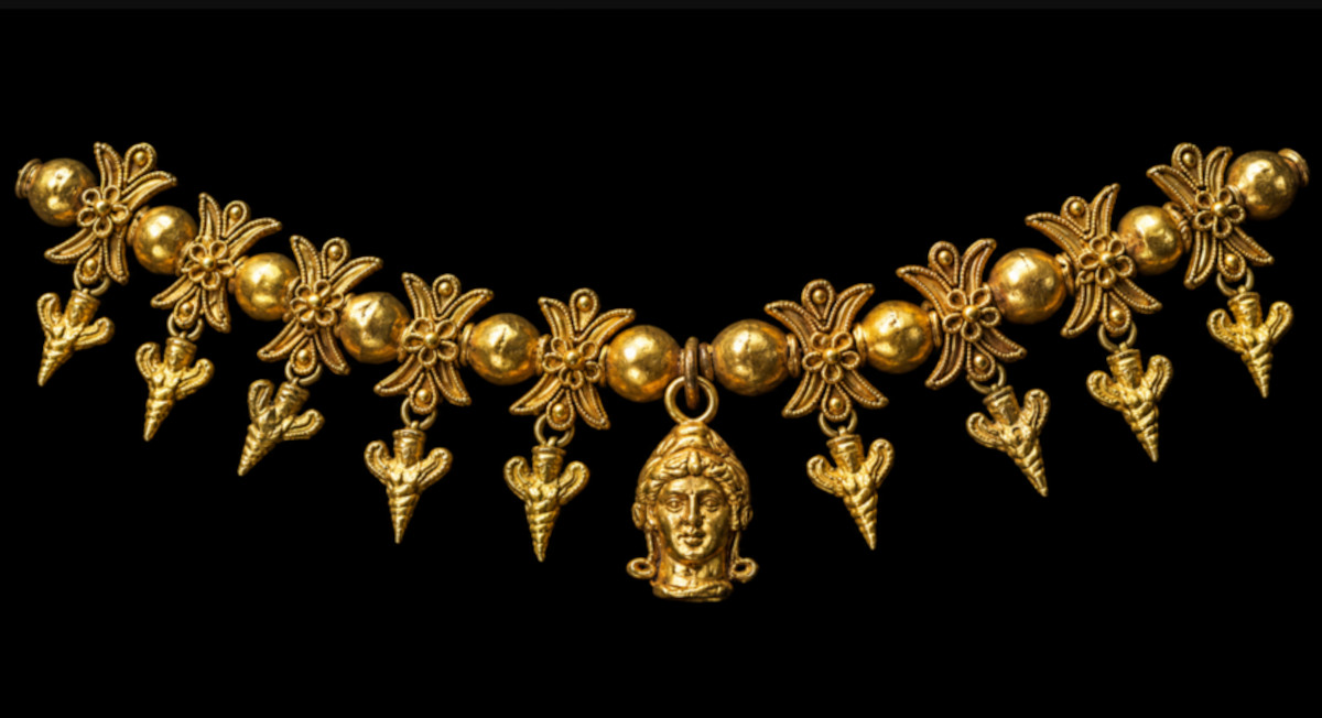 A gold necklace of bee-women