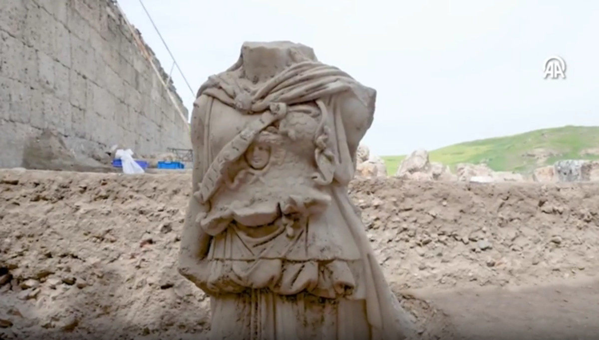 Athena lying face down in a theatre
